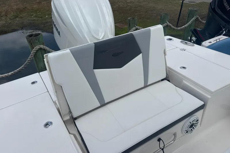 Slide: The Image of 2026 Robalo 246 Cayman boat seat with sleek design and Yamaha engine in background. - 5