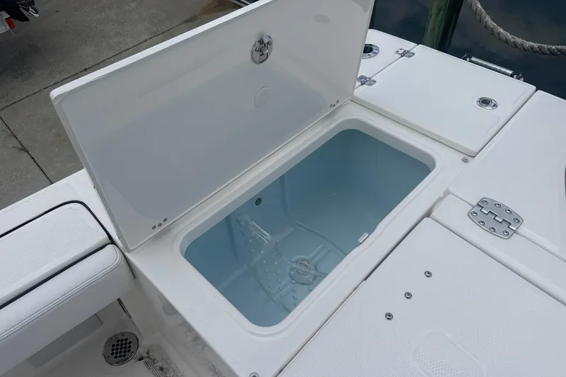 Slide: The Image of Open storage compartment on 2026 Robalo 246 Cayman boat, showcasing interior space. - 8