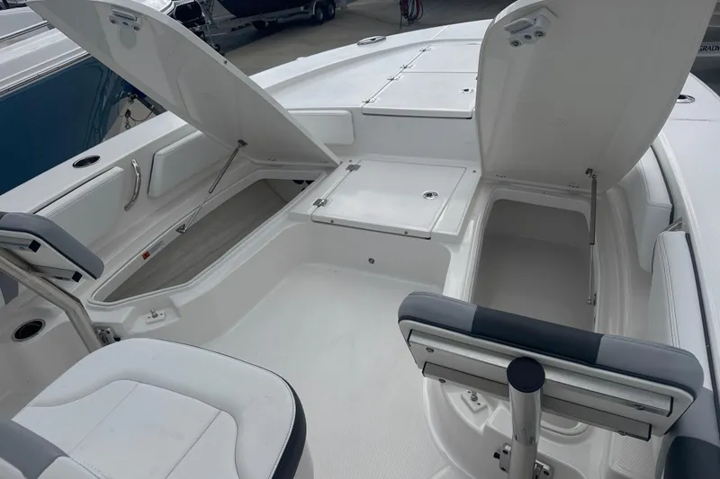 Slide: The Image of 2026 Robalo 246 Cayman boat interior with open storage compartments and seating. - 9