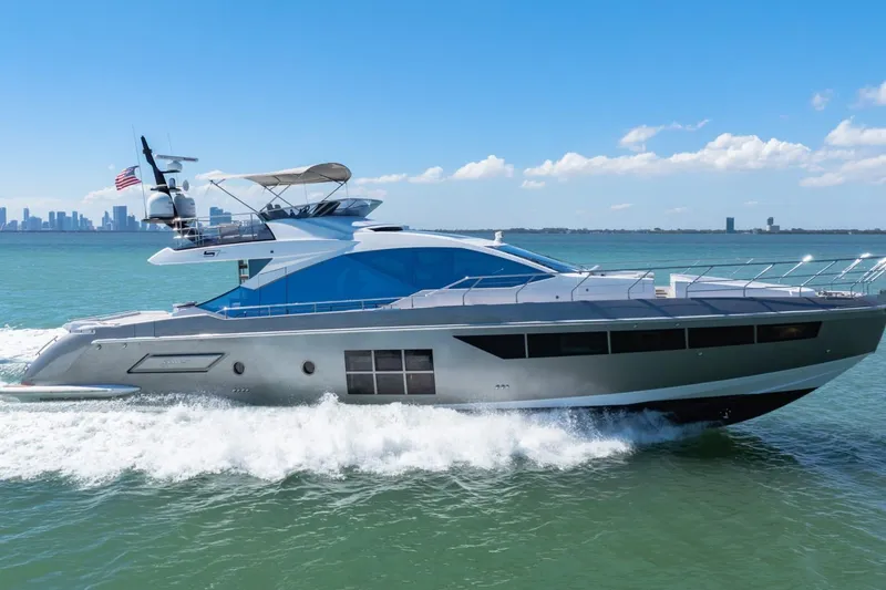 Slide: The Image of Luxurious 2019 Azimut S7 yacht cruising on open water under clear blue skies. - 0