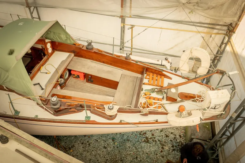Slide: The Image of 1965 Concordia 39 sailboat in dry dock, covered and maintained, with visible deck and equipment. - 10