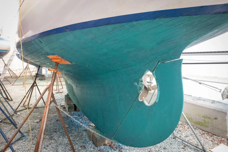 Slide: The Image of 1965 Concordia 39 sailboat hull on stands, showcasing propeller and keel design. - 14