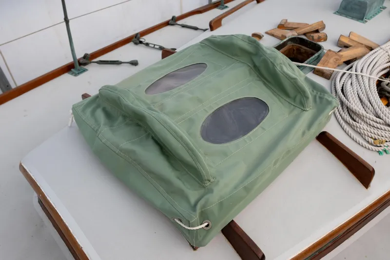 Slide: The Image of Green canvas cover on 1965 Concordia 39 sailboat deck with ropes and wooden blocks. - 17