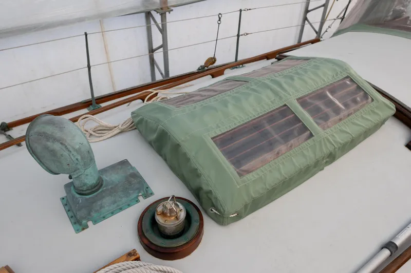 Slide: The Image of Deck of 1965 Concordia 39 sailboat with green canvas cover and ventilation fittings. - 18