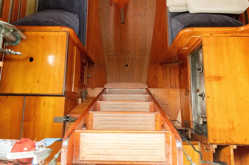 Slide: The Image of Interior of a 1965 Concordia 39 sailboat with wooden cabinetry and ladder. - 26