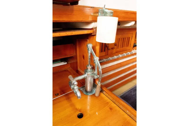 Slide: The Image of Vintage Concordia 39 yacht interior with classic wooden cabinetry and metal pump, 1965 model. - 29