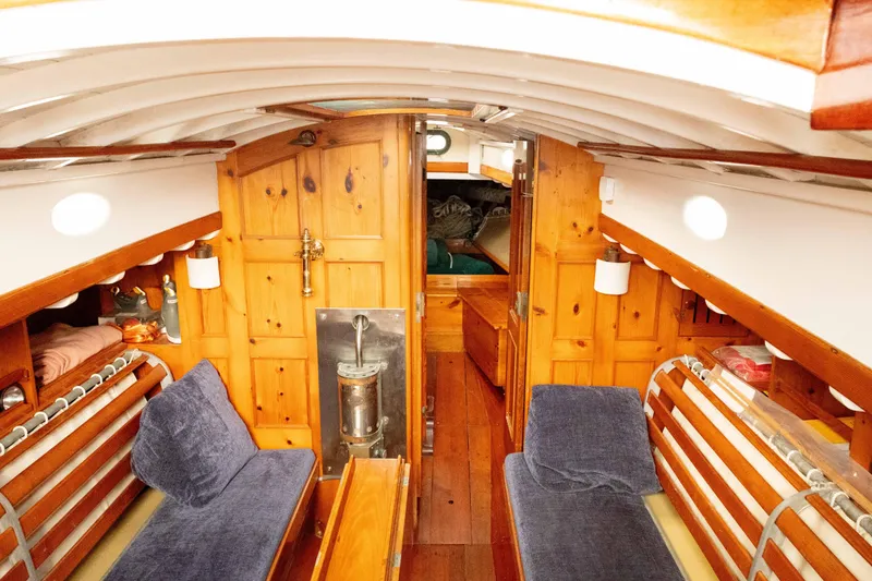 Slide: The Image of Interior of a 1965 Concordia 39 sailboat with wooden paneling and cozy seating. - 30