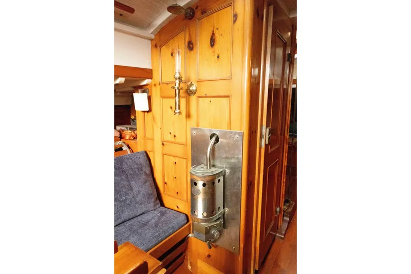 Slide: The Image of Interior of a 1965 Concordia 39 sailboat with wooden paneling and vintage fixtures. - 31