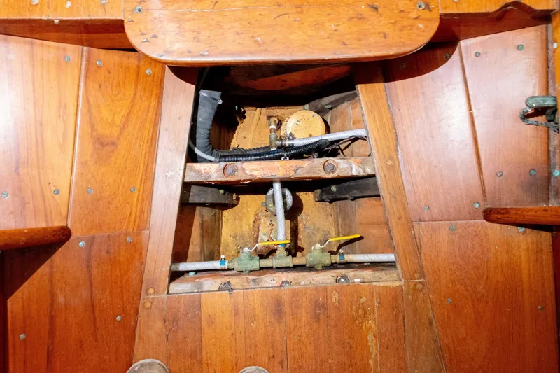 Slide: The Image of Interior view of 1965 Concordia 39 sailboat showing wooden paneling and mechanical components. - 33