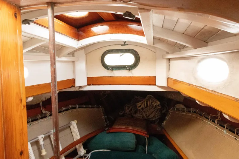 Slide: The Image of Interior of a 1965 Concordia 39 sailboat with wooden accents and cozy seating. - 38