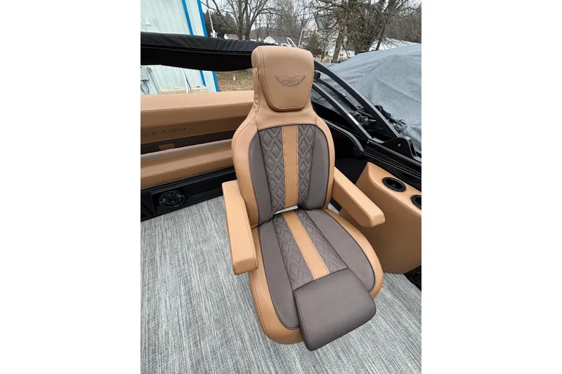 Slide: The Image of Luxurious seating in the 2026 Bennington 22 M Swingback boat, featuring tan and gray upholstery. - 10