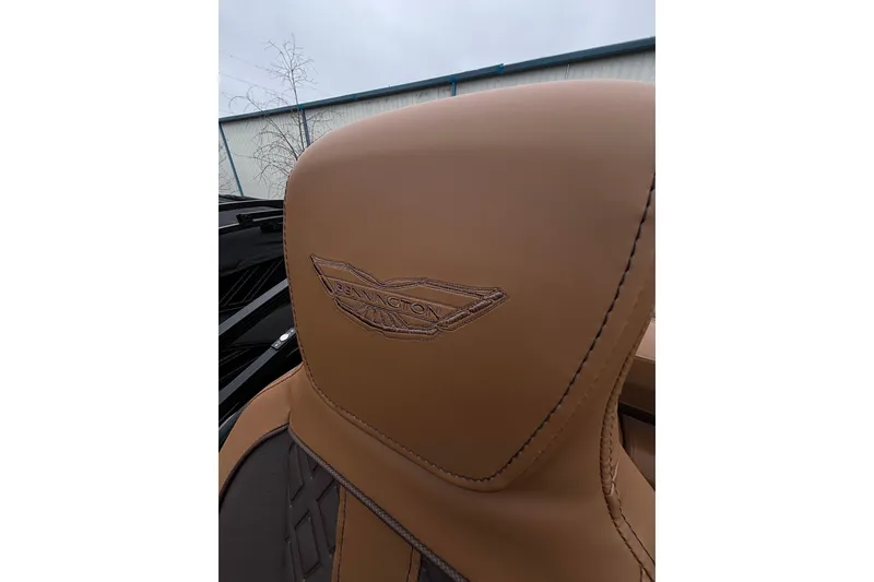 Slide: The Image of Luxurious tan leather seat with Bennington logo on 2026 Bennington 22 M Swingback. - 14