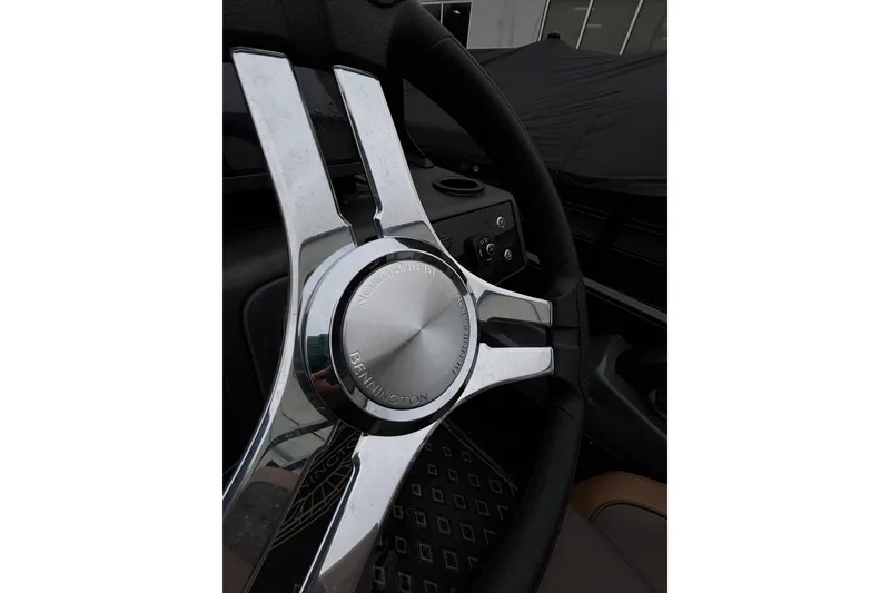 Slide: The Image of Steering wheel of 2026 Bennington 22 M Swingback boat, featuring chrome accents. - 15