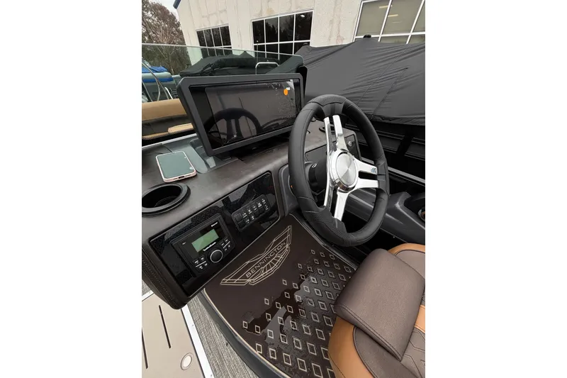 Slide: The Image of 2026 Bennington 22 M Swingback dashboard with steering wheel and touchscreen display. - 17