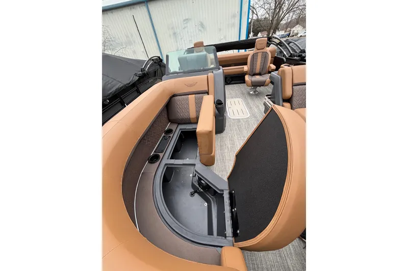 Slide: The Image of 2026 Bennington 22 M Swingback boat interior with tan seating and storage compartments. - 5