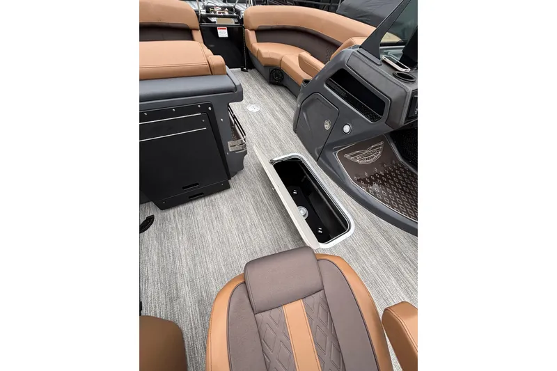 Slide: The Image of 2026 Bennington 22 M Swingback interior with open storage compartment and luxurious seating. - 6