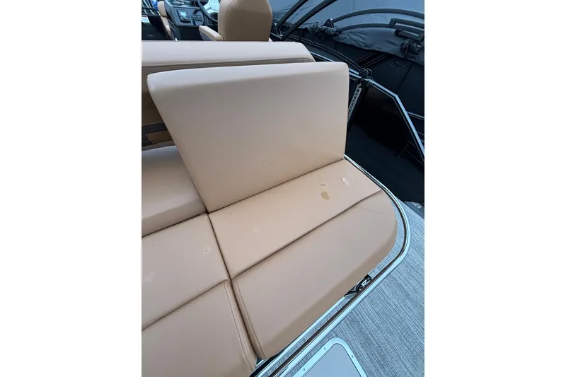 Slide: The Image of 2026 Bennington 22 M Swingback boat seat with tan upholstery and water droplets. - 7