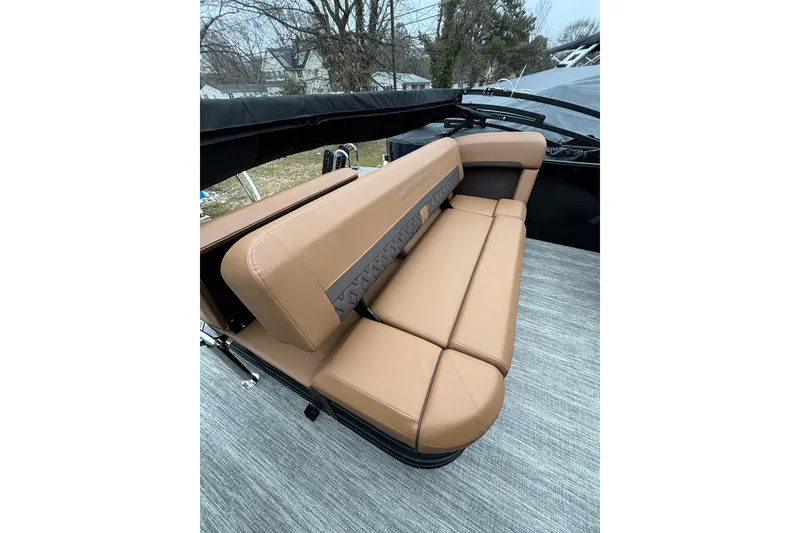 Slide: The Image of 2026 Bennington 22 M Swingback boat with tan leather seating, outdoor setting. - 8