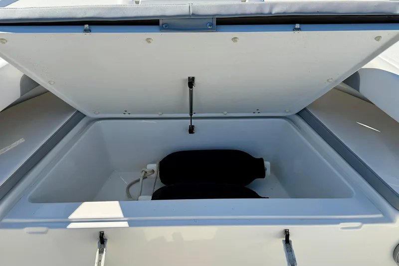 Slide: The Image of Open storage compartment on 2024 Parker 2100 Special Edition boat. - 17