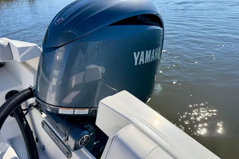 Slide: The Image of 2024 Parker 2100 Special Edition boat with Yamaha outboard motor on water. - 21