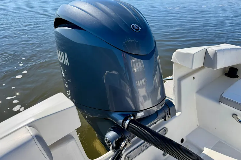 Slide: The Image of 2024 Parker 2100 Special Edition boat with Yamaha outboard motor on calm water. - 22