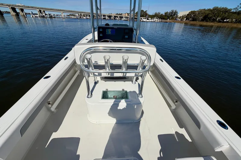 Slide: The Image of 2024 Parker 2100 Special Edition boat interior on calm water, featuring a sleek console design. - 25