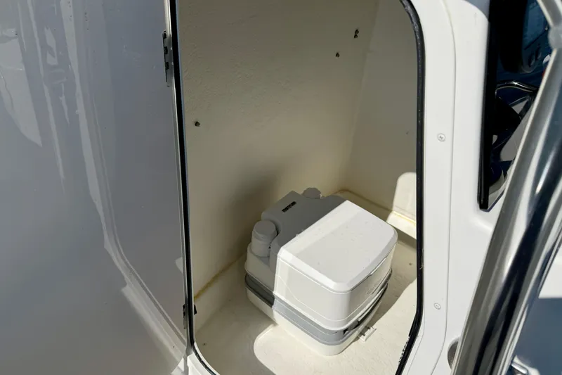 Slide: The Image of Portable toilet inside 2024 Parker 2100 Special Edition boat compartment. - 26