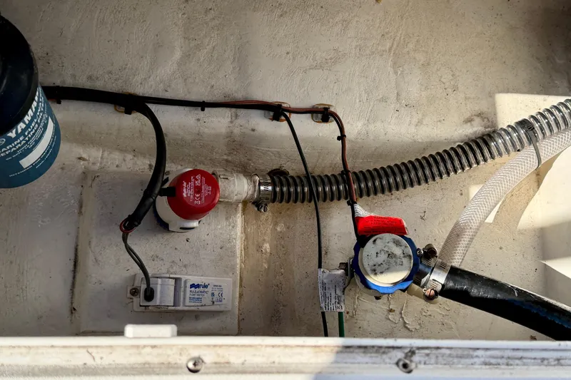 Slide: The Image of 2024 Parker 2100 Special Edition boat bilge area with pump and hoses. - 31