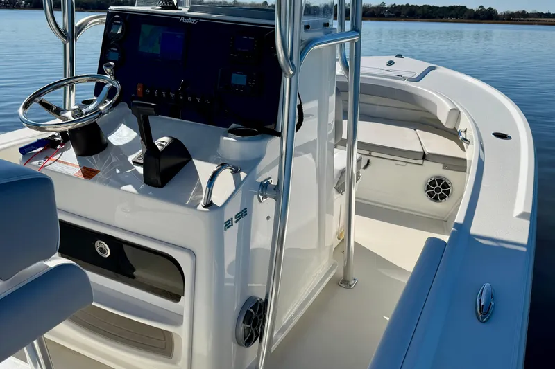 Slide: The Image of 2024 Parker 2100 Special Edition boat interior with steering console and seating. - 33
