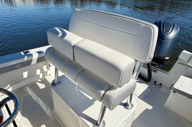 Slide: The Image of 2024 Parker 2100 Special Edition boat with white cushioned seating and steering wheel. - 35