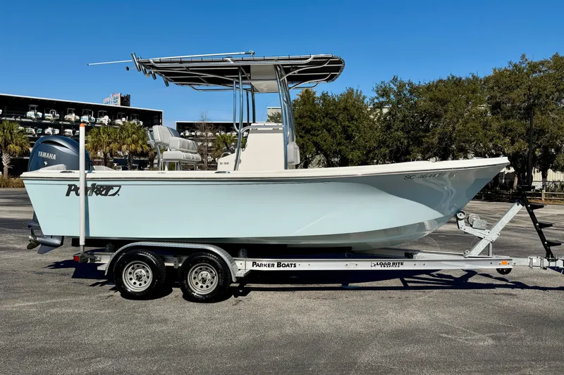 Slide: The Image of 2024 Parker 2100 Special Edition boat on trailer, side view, clear sky background. - 42