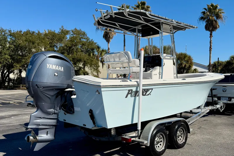 Slide: The Image of 2024 Parker 2100 Special Edition boat with Yamaha engine on trailer, parked outdoors. - 43
