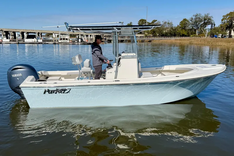 Slide: The Image of 2024 Parker 2100 Special Edition boat on calm water, featuring Yamaha engine. - 5
