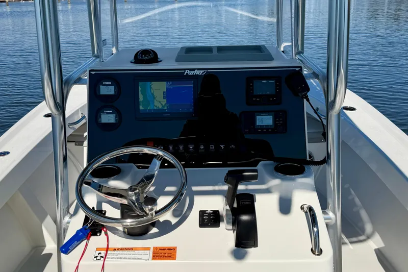 Slide: The Image of 2024 Parker 2100 Special Edition boat dashboard with navigation and control systems on water. - 7
