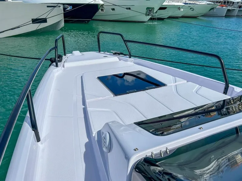 Slide: The Image of 2024 Axopar 25 Cross Top boat docked in a marina. - 5