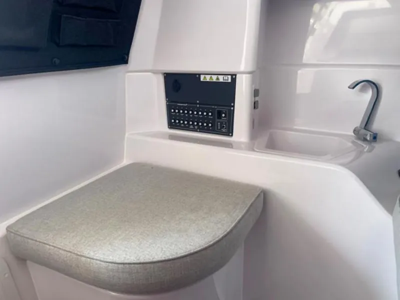 Slide: The Image of 2024 Axopar 25 Cross Top interior with control panel and sink. - 14