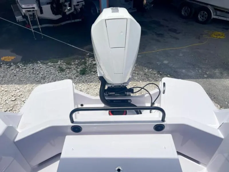 Slide: The Image of 2024 Axopar 25 Cross Top boat with outboard motor, rear view. - 20