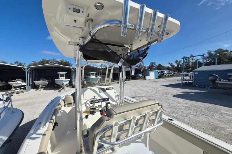 Slide: The Image of 2021 Key West 239 FS boat with T-top and rod holders in a marina setting. - 10