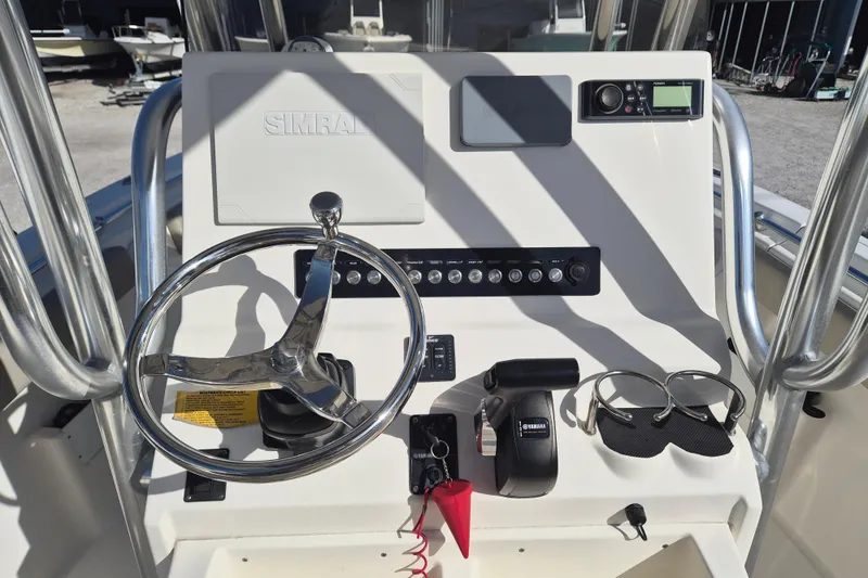 Slide: The Image of 2021 Key West 239 FS boat dashboard with steering wheel and controls. - 11