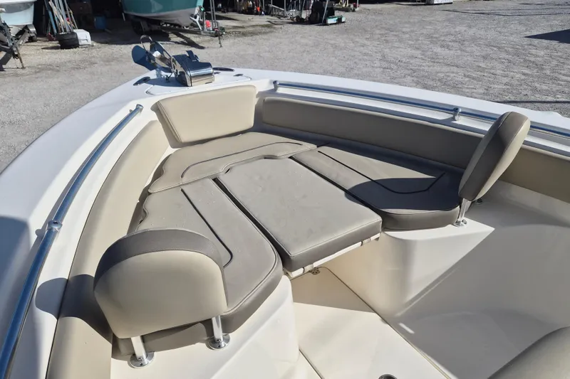 Slide: The Image of 2021 Key West 239 FS boat interior with cushioned seating and stainless steel railings. - 4