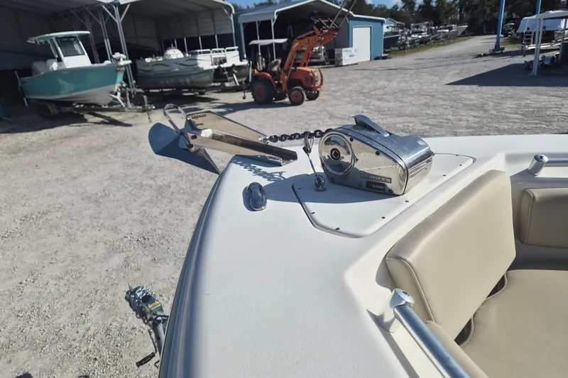 Slide: The Image of 2021 Key West 239 FS boat with anchor and winch in a marina setting. - 7