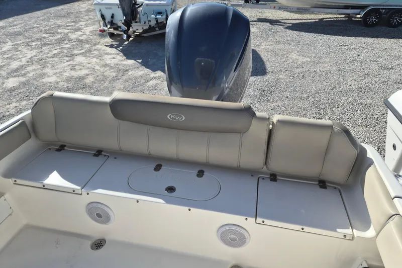 Slide: The Image of 2021 Key West 239 FS boat interior with cushioned seating and storage compartments. - 9