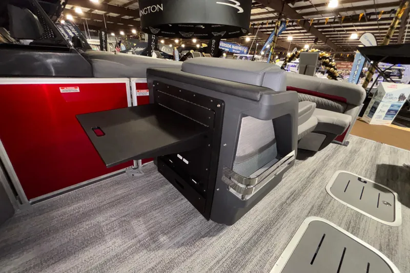 Slide: The Image of 2026 Bennington 23 M Open Fast Back interior with seating and pull-out table. - 8