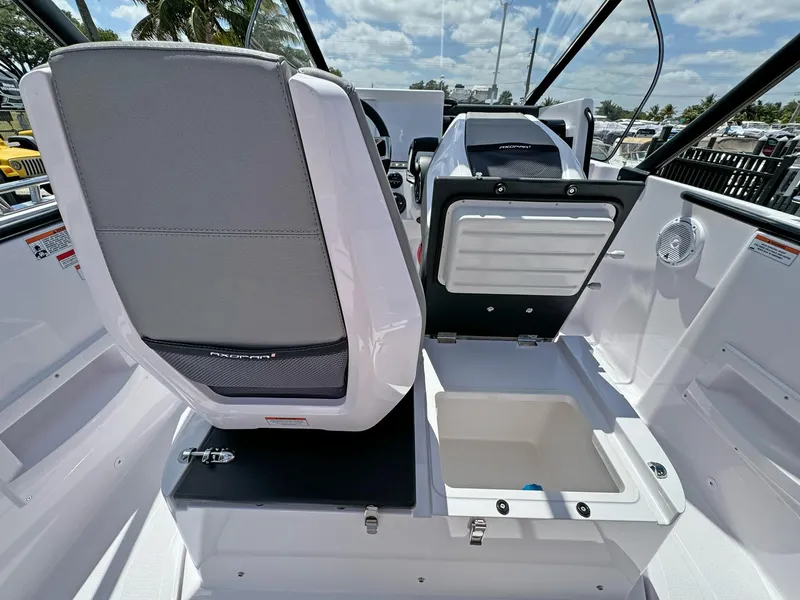 Slide: The Image of 2024 Axopar 25 Cross Top boat interior with seating and storage compartments. - 7