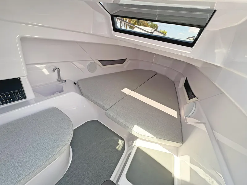 Slide: The Image of 2025 Axopar 25 Cross Top cabin interior with modern design and comfortable seating. - 9