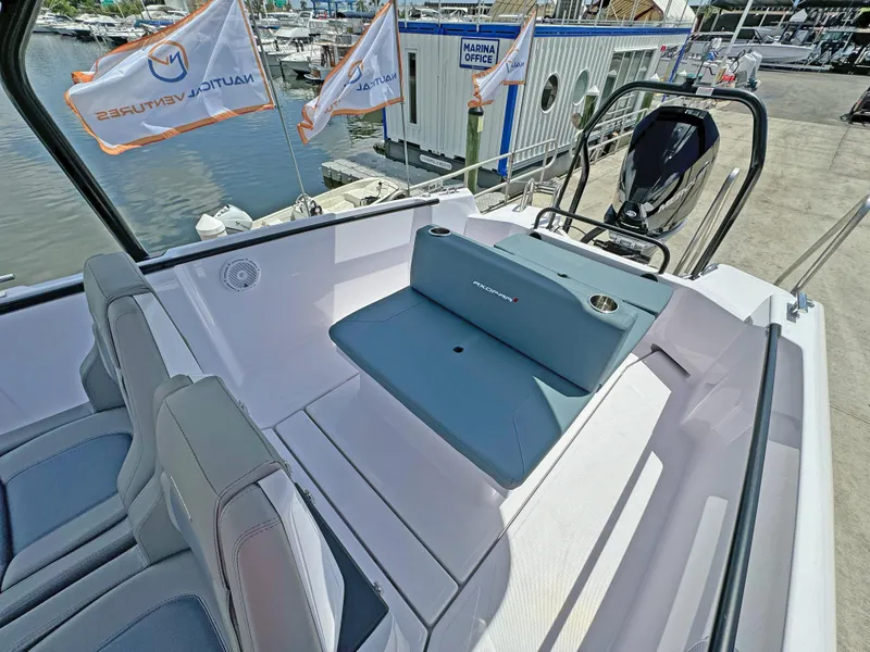 Slide: The Image of 2025 Axopar 25 Cross Top boat interior with seating and marina view. - 6