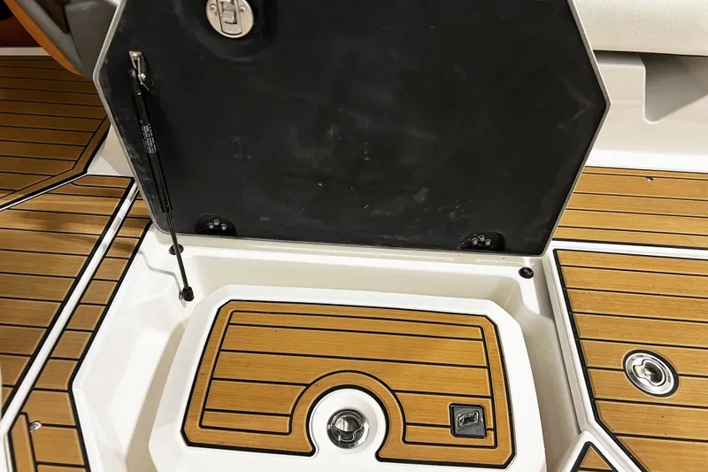 Slide: The Image of 2022 Nautique Super Air Nautique G23 deck with open storage compartment. - 18