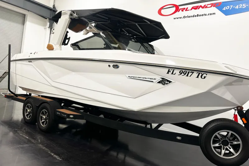 Slide: The Image of 2022 Nautique Super Air Nautique G23 boat on trailer in showroom. - 2