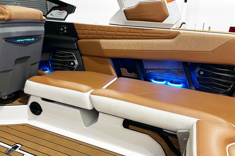 Slide: The Image of 2022 Nautique Super Air Nautique G23 interior with tan seating and blue LED lighting. - 20