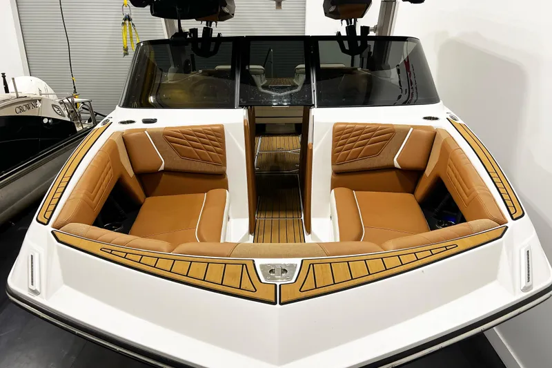 Slide: The Image of 2022 Nautique Super Air Nautique G23 boat with luxurious tan seating and sleek design. - 5